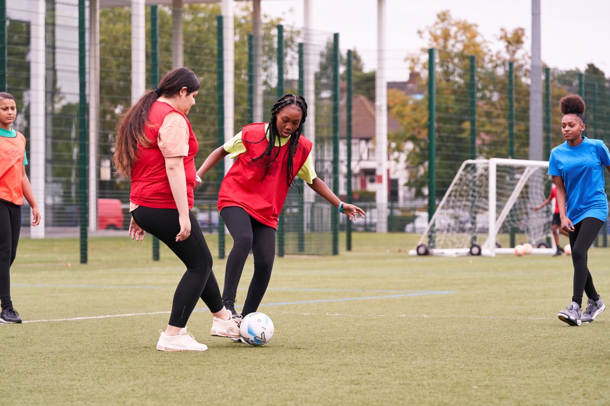 Girls playing football at a multi-sport venue